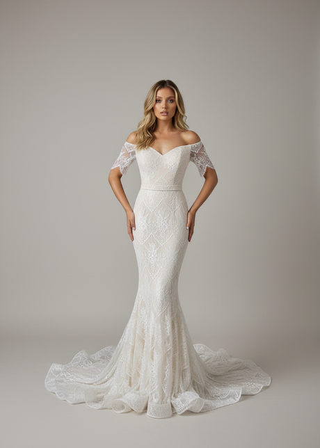 A woman wearing a blue, full-length gown with lace detailing, a sweetheart neckline, off-the-shoulder sleeves, and a mermaid style skirt with a back train.